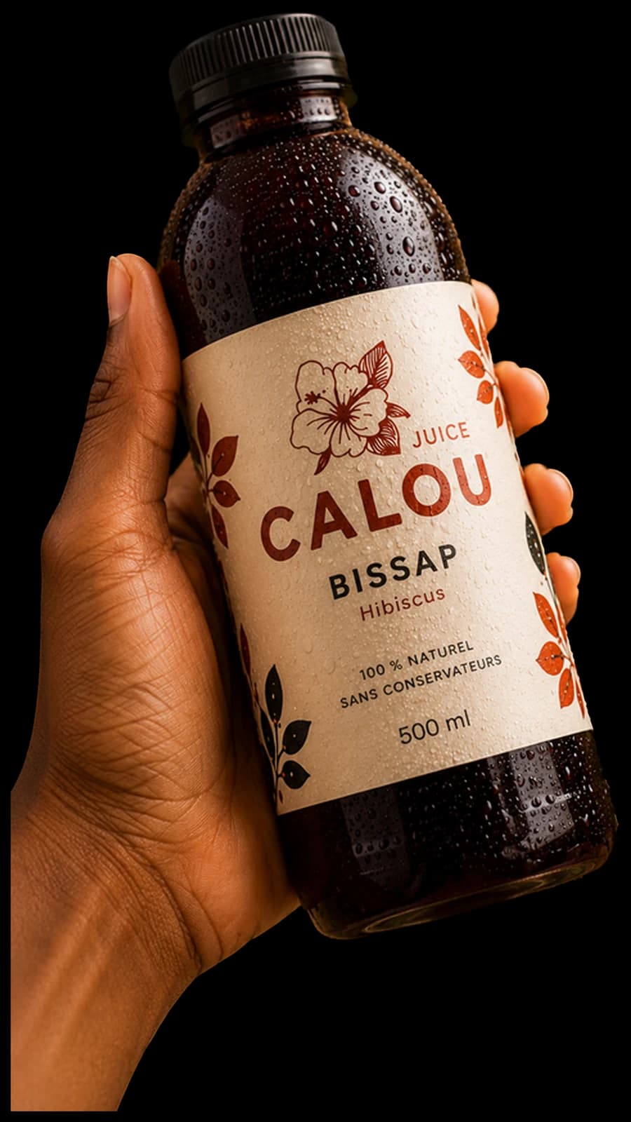 Une main tenant une bouteille de Calou Bissap couverte de buée.